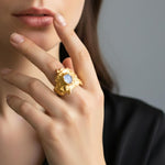 Close-up of a hand wearing a Nyx ring with a moonstone |The Bow Jewelry