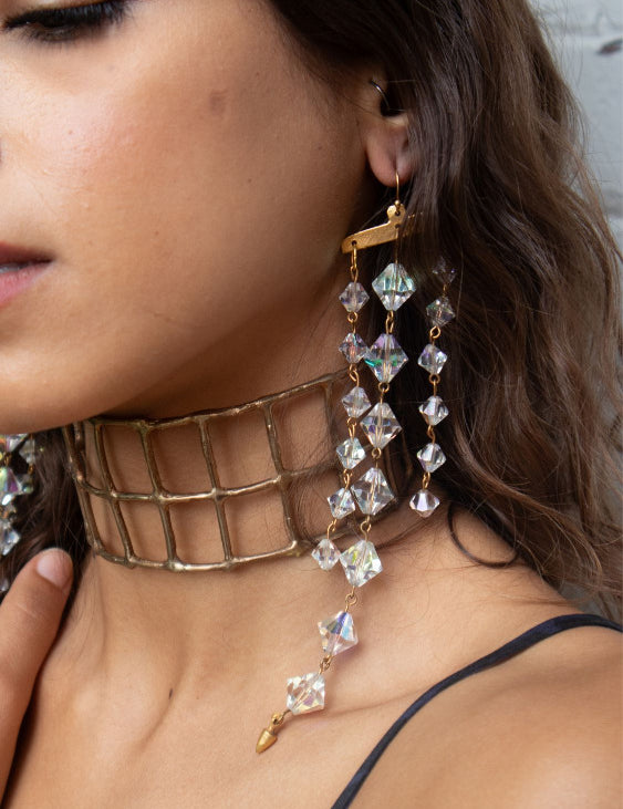 A close-up of model wearing Exotic earrings with upcycled vintage chandelier crystals | The Bow Jewelry