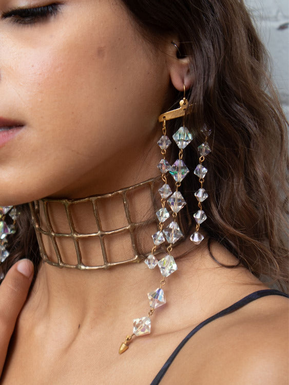 A close-up of model wearing Exotic earrings with upcycled vintage chandelier crystals | The Bow Jewelry